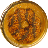 An image of homemade peanut butter with coconut and caramel cookies mixed in.