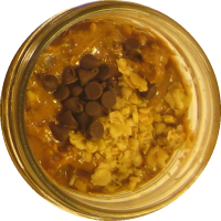 An image of homemade peanut butter with granola and mini-chocolate chips mixed in.