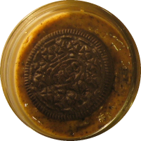 An image of homemade peanut butter with Oreo pieces mixed in.