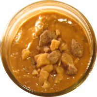 An image of homemade peanut butter with toffee bits mixed in.